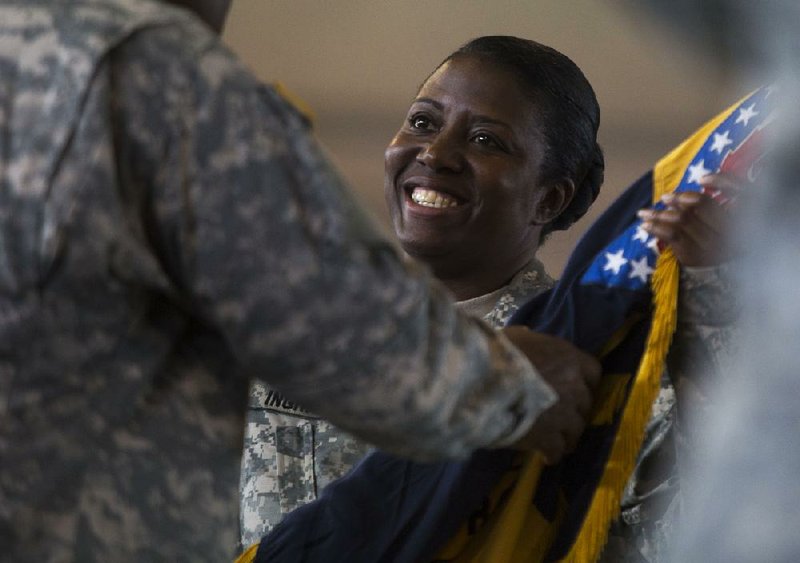 Arkansas Democrat-Gazette/Melissa Sue Gerrits - 07/12/2014 -  LTC Erica L. Ingram receives the colors to symbolize her taking command of the 871st from outgoing commander LTC Dwight D. Ikenberry July 12, 2014 at the Fisher Armory in North Little Rock. 