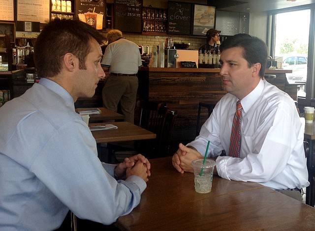 This photo taken June 30, 2014 shows North Carolina Republican Congressional candidate David Rouzer, right, talking with campaign aide Tyler Foote in Raleigh, N.C. Rouzer is favored to win the House seat that North Carolina Democrat Mike McIntyre is surrendering after 18 years. Democrats long have claimed that Republicans abused their legislative powers to elect a disproportionate number of U.S. House members. A court in Florida is lending credence to their complaint, and North Carolina Democrats are fighting a GOP-drawn map in state court. The battles are shining a new light on the fiercely partisan practice of gerrymandering, in which state officials draw congressional districts to help their party. Both parties have done it for decades, but Republicans refined the practice in 2011, a year after they won control of numerous state governments preparing to redraw congressional maps based on the 2010 census. Its one reason Republicans hold a solid House majority even though Americans cast 1.4 million more votes for Democratic House candidates than for GOP House candidates in 2012.