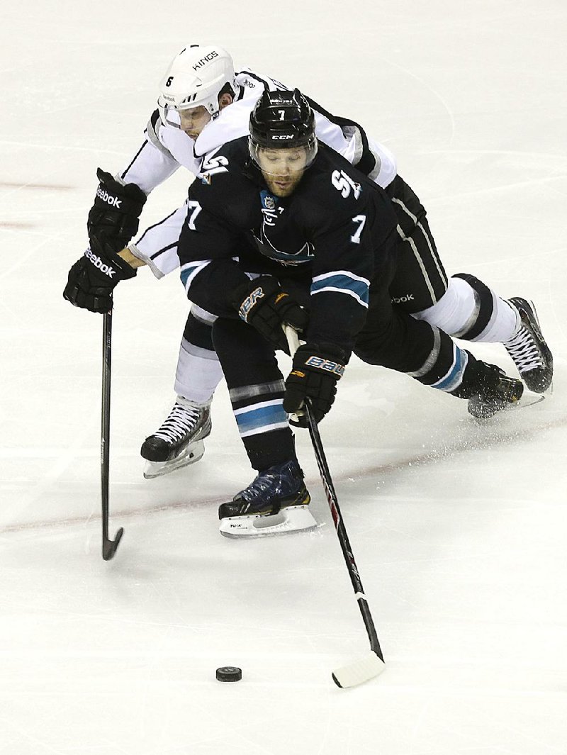 FILE - In this April 3, 2014 file photo, San Jose Sharks defenseman Brad Stuart (7) skates in front of Los Angeles Kings defenseman Jake Muzzin (6) during the first period of an NHL hockey game in San Jose, Calif. The Colorado Avalanche acquired defenseman Brad Stuart from the San Jose Sharks for a second-round pick in 2016 and a sixth-rounder in 2017.  (AP Photo/Jeff Chiu, File)