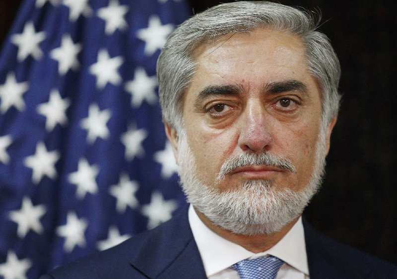 Afghan presidential candidate Abdullah Abdullah listens to U.S. Secretary of State John Kerry during a photo opportunity at the start of a meeting at the U.S. Embassy in Kabul, Friday, July 11, 2014. Kerry sought Friday to broker a deal between Afghanistan's rival presidential candidates as a bitter dispute over last month's runoff election risked spiraling out of control. (AP Photo/Jim Bourg, Pool)