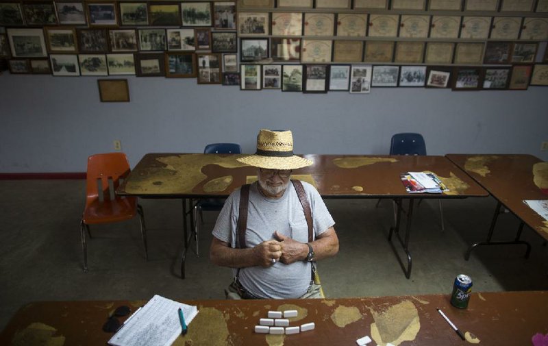 Arkansas Democrat-Gazette/Melissa Sue Gerrits - 07/10/2014 -  Donald Glenn, born and raised in Fisher, plays dominoes in the old City Hall building in Fisher, AR July 10, 2014. The facilities are open as a community room with historical documents and photographs on the walls as well as their dated Fire Department equipment in an adjacent garage. 