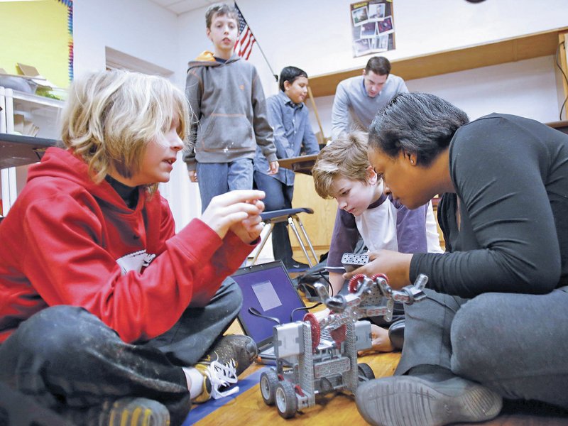 FILE DAVID GOTTSCHALK Maurissa Roberts, right, Projects Lead the Way teacher at Leverett Elementary School, works with Kele Estes-Beard, from left, Grady Gottschalk, Anshuman Nandy, assistant principal Joe McClung and Joseph Casey on Feb. 26 at the Fayetteville School.