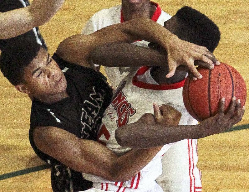 Arkansas Democrat-Gazette/BENJAMIN KRAIN --07/14/2014--
Noah Pope, left, with Teampenny, tries to steal the ball from Exavian Christon, with Arkansas Wings Elite,  during the AAU National Championship game held Monday afternoon at Philander Smith College in Little Rock. 