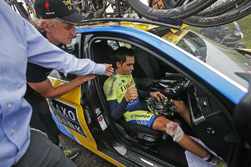 Spain's Alberto Contador is consoled after he abandoned race after crashing during the tenth stage of the Tour de France cycling race over 161.5 kilometers (100.4 miles) with start in Mulhouse and finish in La Planche des Belles Filles, France, Monday, July 14, 2014. (AP Photo/Christophe Ena)