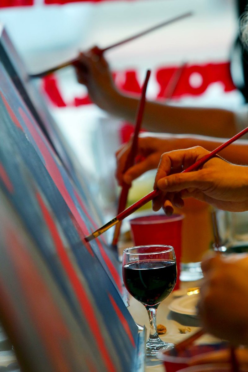 6/12/14
Arkansas Democrat-Gazette/STEPHEN B. THORNTON
Red wine and drink help lubricate the creativity during a paint night Thursday at Gusano's in the River Market.