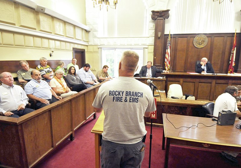 STAFF PHOTO BEN GOFF &#8226; @NWABenGoff Jason Harte, a volunteer with Rocky Branch Fire and EMS East of Rogers, addresses the Benton County justices of the peace during a Benton County public hearing regarding the funding of rural ambulance service on Monday in the Benton County Courthouse in Bentonville.