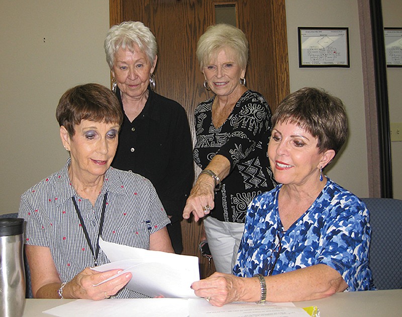 Submitted photo FINAL PREPARATIONS: Front, from left, Phillis Ruggieri and Lynn Holberton discuss final plans for the Crystal Chimes Mardi Gras show on Sept. 20 with Mary Homan and Lynn Petty.