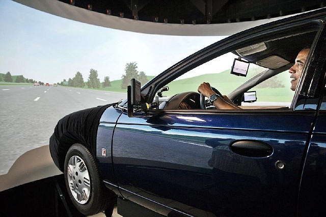 President Barack Obama tries out a driving simulator Tuesday during a visit to the Turner-Fairbank Highway Research Center in McLean, Va. During the visit, he said he supports lawmakers’ efforts to keep highway money flowing temporarily but warned that “Congress shouldn’t pat itself on the back for averting disaster for a few months.”