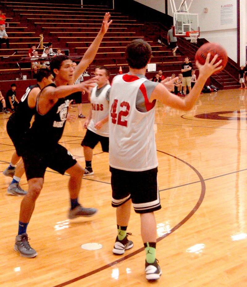 Photo by Mike Eckels Decatur&#8217;s Mario Urquidi blocks a Farmington player from the goal forcing him to pass outside. The Bulldogs played the Farmington Cardinals in the first game of the Gentry Summer League July 10. Decatur posted the victory 18 to 14.