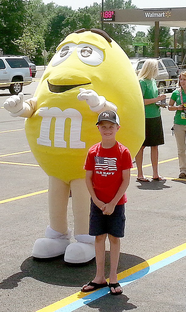 A child posed with the M&amp;M character at the community event Saturday.