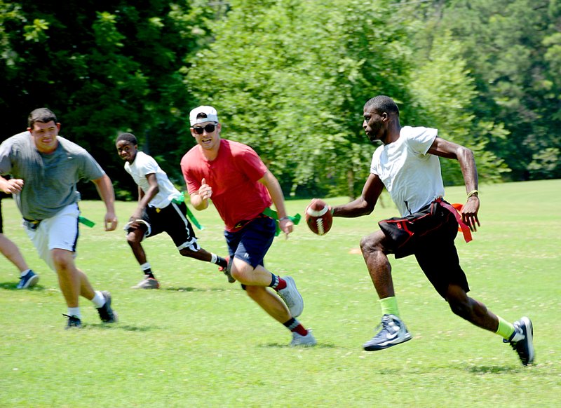 Janelle Jessen/Herald-Leader Waylon Brown ran the ball during a game of flag football at the training camp.