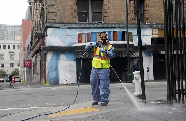 Eighi Hiastake, of the San Francisco Dept. of Public Works, washes a city sidewalk with a mixture of water and detergent on Tuesday, July 15, 2014, in San Francisco. In one of the most drastic responses yet to California's drought, state regulators on Tuesday will consider fines of up to $500 a day for people who waste water on landscaping, fountains, washing vehicles and other outdoor uses. The rules would prohibit watering of landscaping to the point that runoff spills onto sidewalks or streets. Hosing down sidewalks, driveways and other hard surfaces would be prohibited, as would washing vehicles without a shut-off nozzle. 