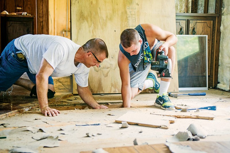 J.R. Privitt, left, and Colton McCollom of First Baptist Church of Farmersville, Texas, work to renovate a donated mobile home in Conway for Stand Together And No Drugs. The program, founded by Suzanne Gonzalez, helps women struggling with drug or alcohol addiction by providing them a place to stay, counseling, Bible studies and life-skills classes.