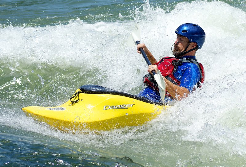 Staff Photo by Randy Moll
Charles Cole, of Siloam Springs, rides the whitewater in Siloam Springs new park on the Illinois River on Friday afternoon. The Siloam Springs Whitewater Recreation Park is a favorite of local kayakers.