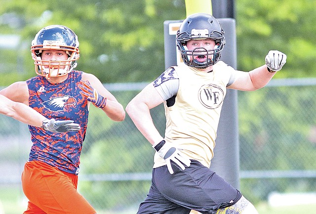  Special To NWA Media David J. Beach Briant Bowerman, right, of West Fork tries to get open for a pass Monday during the NWA Passing League against Rogers Heritage at Tiger Stadium in Bentonville.