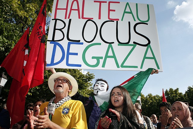 Pro-Palestinian demonstrators shout anti Israeli slogans during a protest against the Israeli army's bombings in the Gaza strip, in Paris, Wednesday, July 16, 2014. Placard reads: "Stop the blockade of Gaza". 