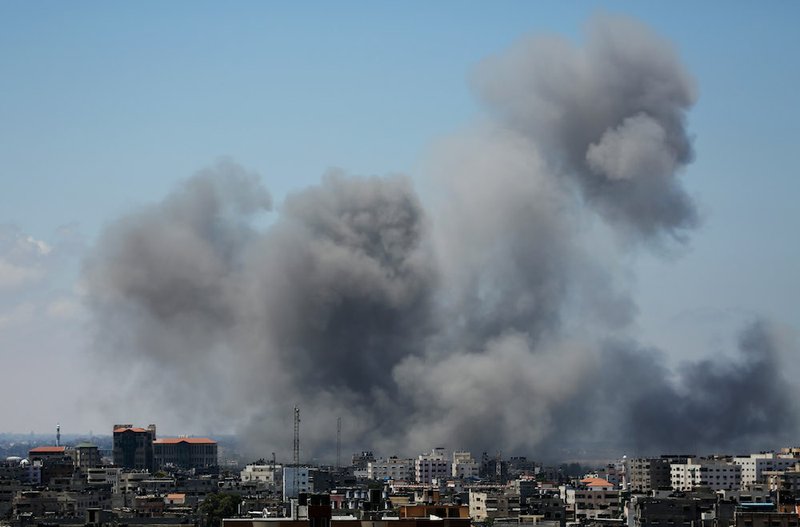 Smoke rises after an Israeli missile strike in Gaza City on Friday, July 18, 2014. Israel intensified its 11-day campaign against Hamas by sending in tanks and troops late Thursday after becoming increasingly exasperated with unrelenting rocket fire from Gaza on its cities, especially following Hamas' rejection of an Egyptian cease-fire plan earlier in the week.