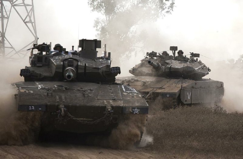 Israeli tanks roll near the Gaza border Friday. Israeli Prime Minister Benjamin Netanyahu said he had ordered the military to prepare for a “significant expansion” of the ground offensive against Hamas.