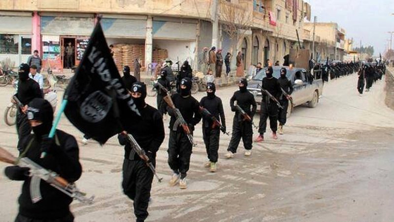 This undated file image posted on a militant website on Tuesday, Jan. 14, 2014, which has been verified and is consistent with other AP reporting, shows fighters from the al-Qaida linked Islamic State of Iraq and the Levant (ISIL) marching in Raqqa, Syria. Across the broad swath of territory it controls from northern Syria through northern and western Iraq, the extremist group known as the Islamic State has proven to be highly organized governors.
