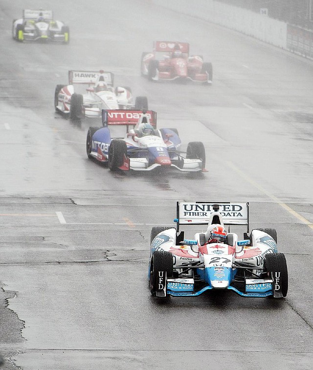 Canada’s James Hinchcliffe (27) leads the field around the track under a caution flag ahead of what was supposed to be the first IndyCar auto race of a weekend doubleheader in Toronto on Saturday.