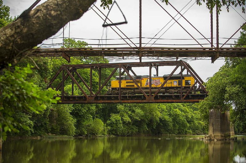 7/9/14
Arkansas Democrat-Gazette/STEPHEN B. THORNTON
A Union Pacific train crosses the Saline River beyond Benton's abandoned River Street Bridge Wednesday.  The River Street Bridge, completed in 1891, is the focal point of a planned 200th birthday celebration in 2015.  FOR WEEKEND STORY adgxsalinewk