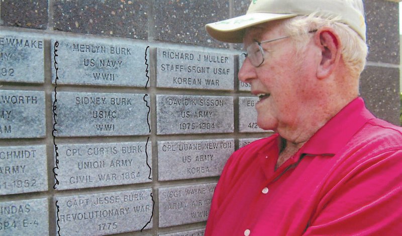 Courtesy Photo Merlyn &#8220;Red&#8221; Burk proudly examines the Wall of Honor in Bella Vista where he bought four stones to honor the men in his family who served the United States since the Revolutionary War. Stones read from top, Merlyn Burk, U.S. Navy, World War II; Sidney Burk, U.S. Marine Corps, World War I; Corporal Curtis Burk, Union Army, Civil War; and Captain Jesse Burk, Revolutionary War, 1775. Merlyn&#8217;s son, Thomas Burk, served in the Vietnam War but there were no stones available to add him to the wall. He also had three brothers and a sister who served in World War II.