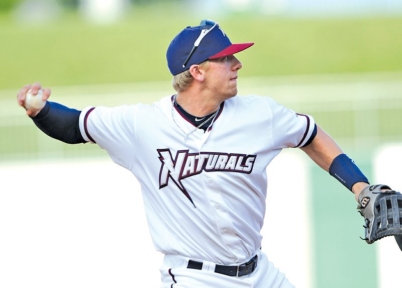  STAFF PHOTO ANDY SHUPE Hunter Dozier, Northwest Arkansas Naturals third baseman, makes a throw to first against the Tulsa Drillers on June 20 at Arvest Ballpark in Springdale.
