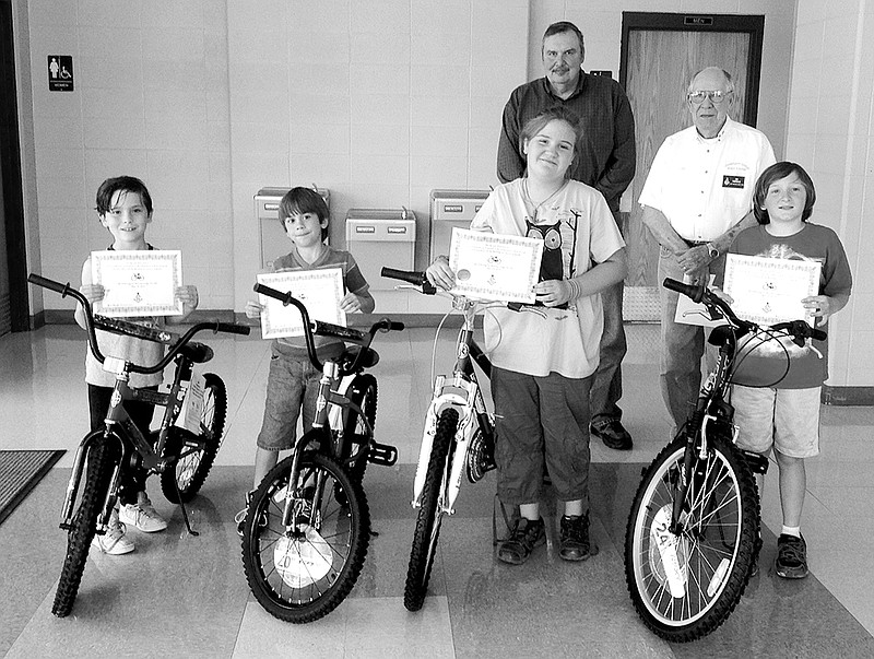 Submitted photo Whittington Masonic Lodge 365 representatives Wayne Cox, back left, Lee Smith and Worshipful Master Jim Swindle, back right, attended an assembly May 19 to present the winners of the Accelerated Reader Contest at Fountain Lake Elementary with new bicycles and certificates. The Lodge sponsors the contest for all Fountain Lake students in grades 2-4. A students is allowed to put their name in the bike drawing contest every time they accomplish reading goals. Winners, from left, were Brett Galbraith, third grade; Toxey Ahrabli, second grade; Starla Hensley, overall winner; and Malachi Thornton, fourth grade.