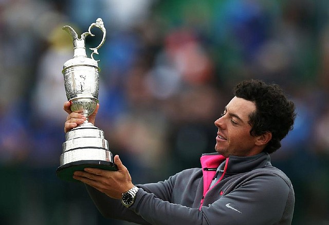 Rory McIlroy of Northern Ireland holds up the Claret Jug trophy after winning the British Open Golf championship at the Royal Liverpool golf club, Hoylake, England, Sunday July 20, 2014. (AP Photo/Scott Heppell)
