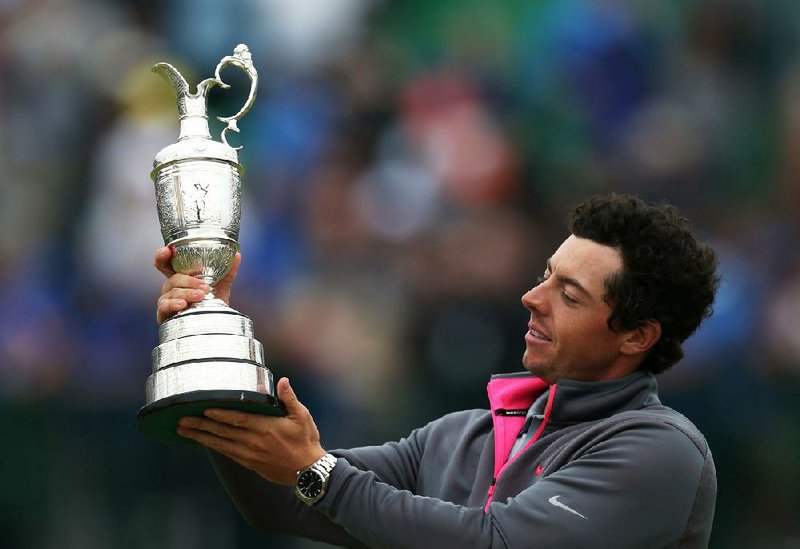 Rory McIlroy of Northern Ireland holds up the Claret Jug trophy after winning the British Open Golf championship at the Royal Liverpool golf club, Hoylake, England, Sunday July 20, 2014. (AP Photo/Scott Heppell)