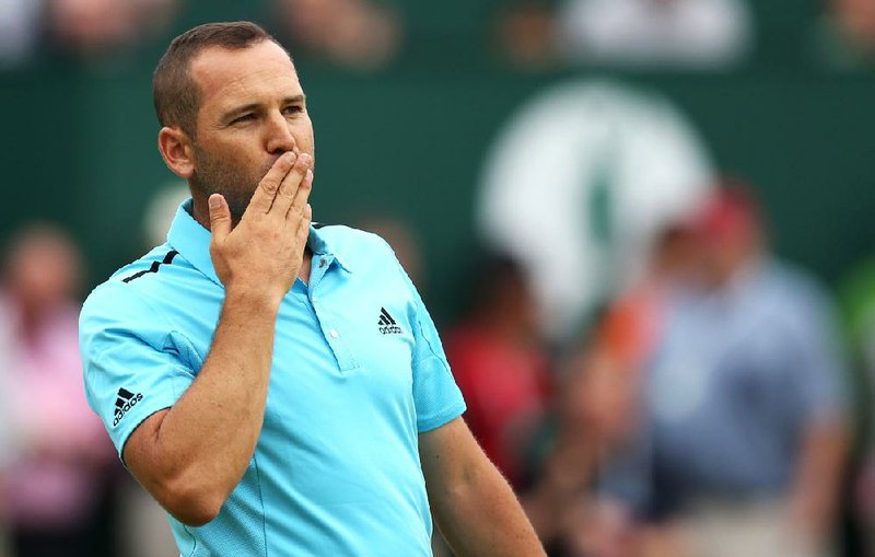 Sergio Garcia of Spain blows kisses to the crowd after completing his final round on the 18th green in the British Open Golf championship at the Royal Liverpool golf club, Hoylake, England, Sunday July 20, 2014. (AP Photo/Scott Heppell)