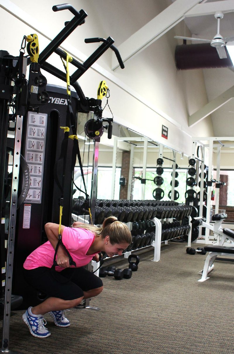 Arkansas Democrat-Gazette/CELIA STOREY
Paisley Sowell does the 2nd step of the TRX Frog Squat exercise at Little Rock Racquet Club for ActiveStyle's Master Class column.