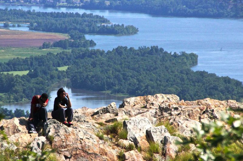 A couple enjoys a quiet moment and the view of the Arkansas River from on top of Pinnacle Mountain. At Pinnacle Mountain State Park.

Most climbers use the easier (but still steep and rocky) West Summit Trail, but those with sturdy knees and plenty of time can try the East Summit for bragging rights.
Both trails are about 1.5 miles round trip

Arkansas Democrat-Gazette/MICHAEL STOREY