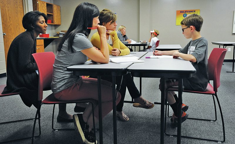 STAFF PHOTO ANDY SHUPE Jackson answers math problems Wednesday while Jessup, from left, Henry and Canada listen.