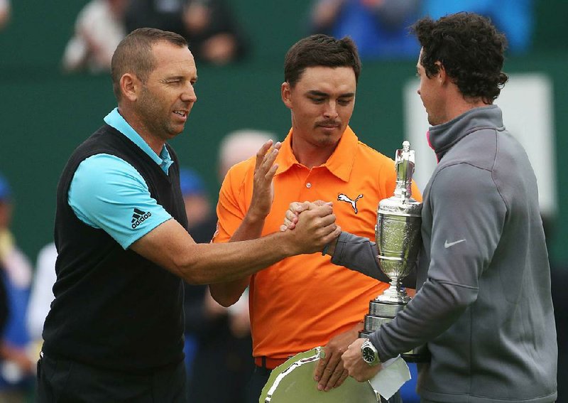 Rory McIlroy (right) shakes hands with second-place fi nishers Sergio Garcia (left) and Rickie Fowler after winning the British Open at the Royal Liverpool golf club in Hoylake, England, on Sunday.