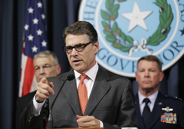 Texas Gov. Rick Perry speaks at a news conference Monday in the governor’s press room in Austin, Texas.