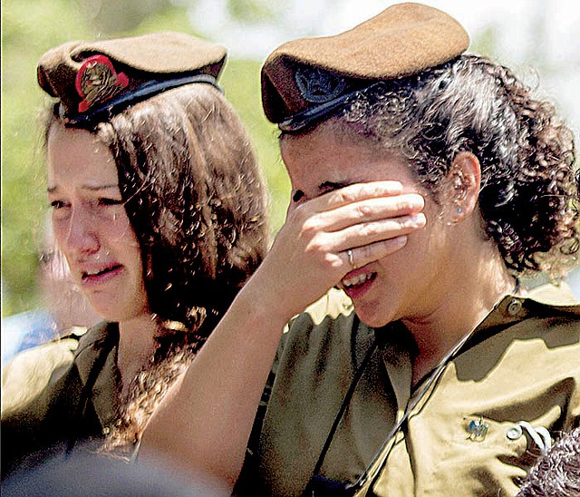 Israeli soldiers mourn Monday during the funeral of Maj. Tzafrir Bar-Or, 32, one of 13 soldiers killed in fighting in Shijaiyah on Sunday, at the military cemetery in Holon, Israel.