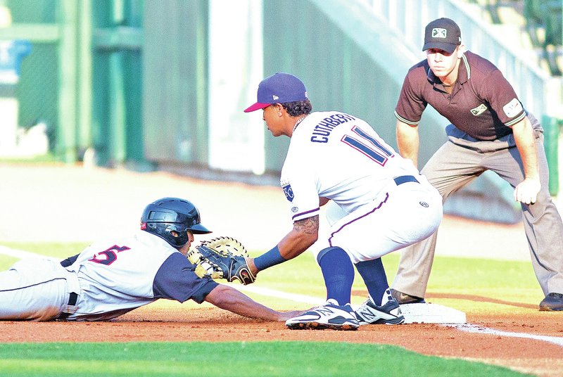 Special to NWA Media David J. Beach Maikol Gonzalez of the Travelers gets picked off Monday by first baseman Cheslor Cuthbert of the Naturals at Arvest Ballpark in Springdale.