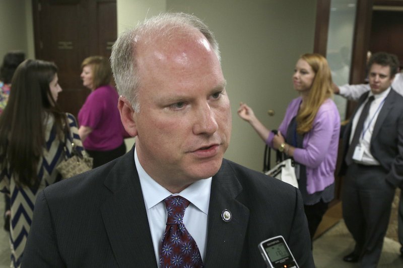 Arkansas Attorney General Dustin McDaniel is interviewed after a meeting of the Claims Review Subcommittee of the Legislative Council in Little Rock on Tuesday, July 8, 2014. 