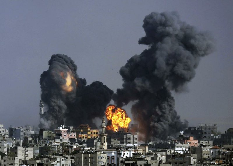 Smoke and fire from the explosion of an Israeli strike rise over Gaza City, Gaza Strip, Tuesday, July 22, 2014, as Israeli airstrikes pummeled a wide range of locations along the coastal area and diplomatic efforts intensified to end the two-week war. (AP Photo/Hatem Moussa)