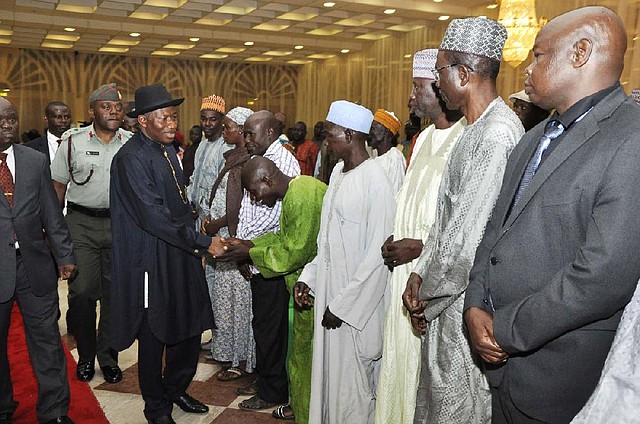Nigeria President, Goodluck Jonathan, third left, greets parents of the kidnapped girls of the Chibok government secondary, in Abuja, Nigeria. Tuesday, July 22, 2014. The Nigerian president met for the first time with parents of 219 kidnapped Nigerian schoolgirls and dozens of classmates who managed to escape from their Islamic extremist captors. Jonathan assured them of his determination that those still in captivity "are brought out alive," presidential spokesman Reuben Abati told reporters after the meeting.  (AP Photo)