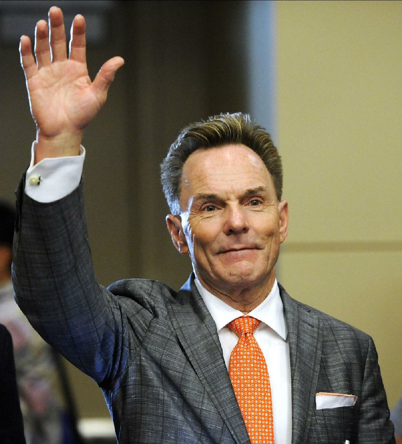 The Rev. Ronnie Floyd of Cross Church in northwest Arkansas waves shortly after being elected the new president of the Southern Baptist Convention during its annual meeting Tuesday, June 10, 2014, in Baltimore. Floyd received 52 percent of votes cast by delegates to the annual meeting of the nation's largest Protestant denomination. (AP Photo/Steve Ruark)