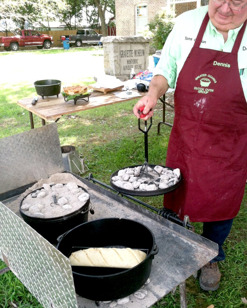 Submitted Photo Dennis, from a Dutch-oven group, prepares to cook a dish during the 2013 event at the Gravette Historical Museum.