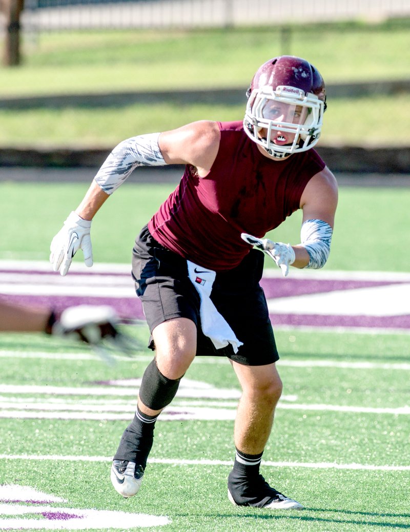 Photo by Anthony Reyes Jake Faulkenberry, of Gentry, rushes toward the ball July 14 in a 7-on-7 game at Harmon Field in Fayetteville.