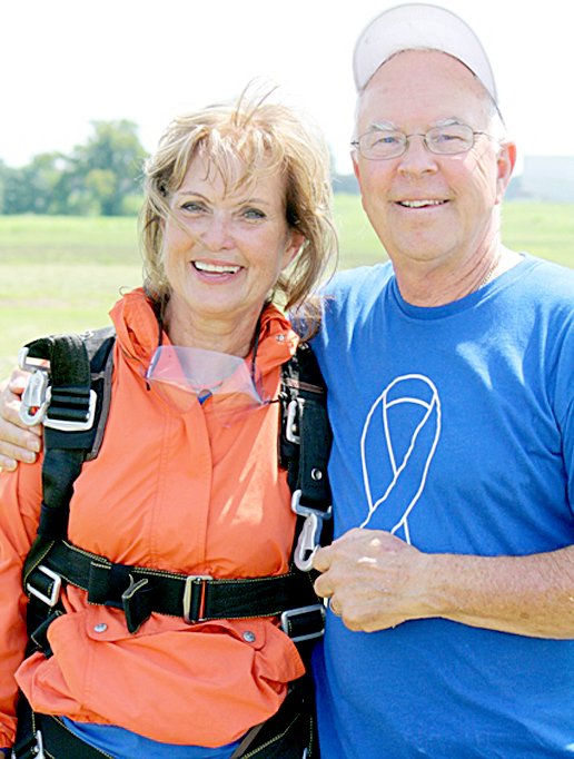 Photo Submitted Beverly Engle, CAC Executive Director, poses with her husband, David, after she lands during the 2013 Sky Dive for Kids.