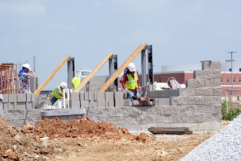 Janelle Jessen/Herald-Leader Masons began laying concrete blocks for the walls of the concession stand of the new Panther Stadium on Monday.