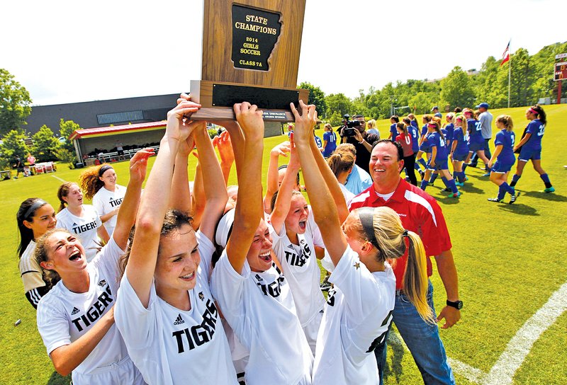 STAFF PHOTO JASON IVESTER Bentonville players celebrate their Class 7A state girls soccer championship following the Lady Tigers&#8217; 3-2 victory May 24 over Bryant at Razorback Field in Fayetteville. It was one of eight state titles for Bentonville, which won the CBS MaxPreps Cup title for the nation&#8217;s best high school athletic program.