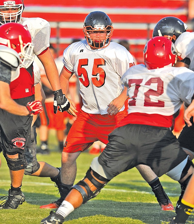  Staff Photo Michael Woods Avery Burrow, Gravette lineman, runs drills Monday evening during a team football camp at Farmington High School.