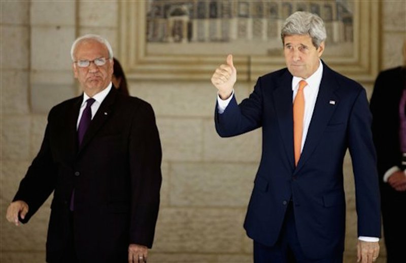 U.S. Secretary of State John Kerry, right, and chief Palestinian negotiator Saeb Erekat arrive to a meeting with Palestinian President Mahmoud Abbas in the West Bank city of Ramallah on Wednesday, July 23, 2014.