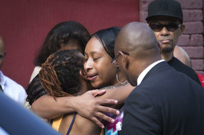 Ellisha Flagg, sister of Eric Garner, center, arrives at the funeral service of her brother, the 43-year-old New York City man whose death while in police custody has led to accusations of police misconduct, at Bethel Baptist Church, Wednesday, July 23, 2014, in the Brooklyn borough of New York. (AP Photo/John Minchillo)